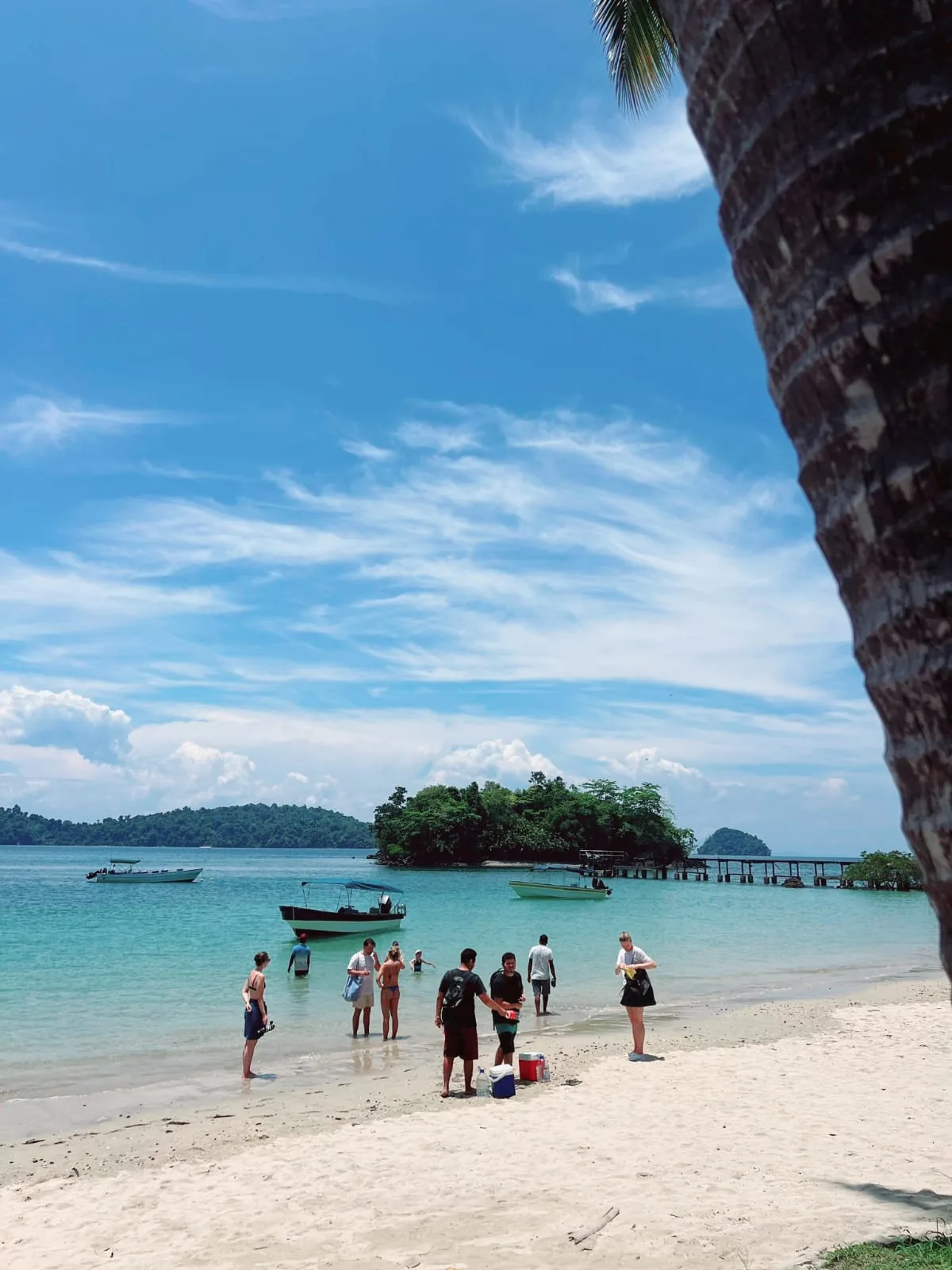 Coiba Island beach with boats and pier